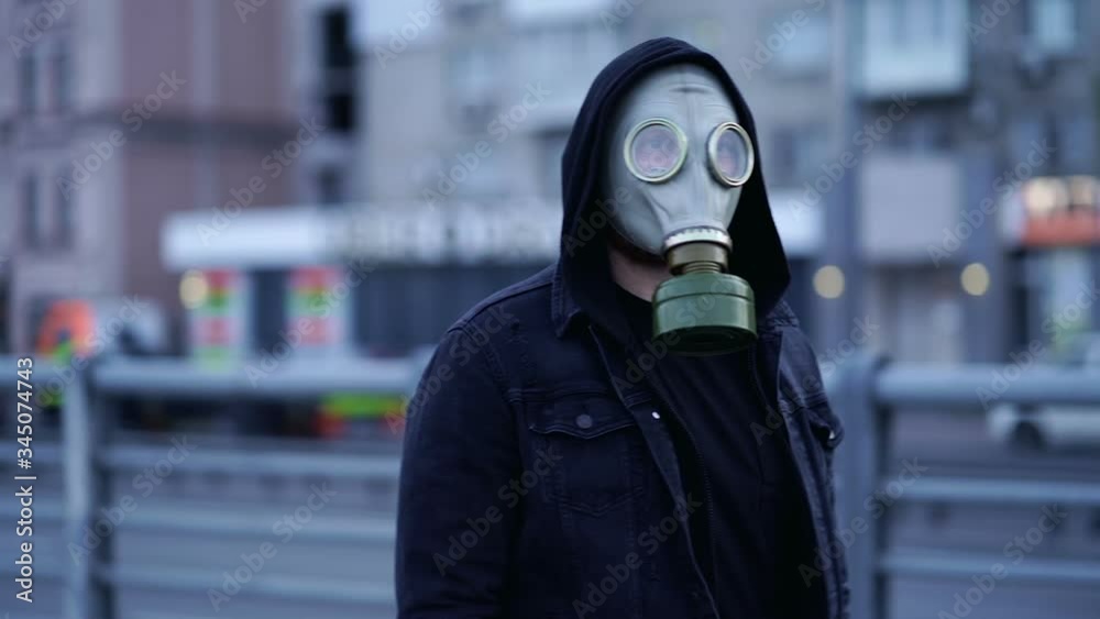 Man with gas mask walking at the street. Slowmotion. Man with gas mask walking at the street. Slowmotion.