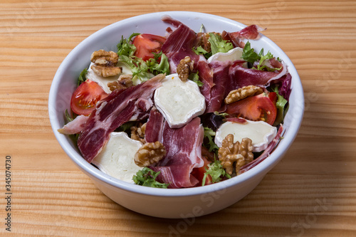 Fresh salad with cheese, nuts and ham