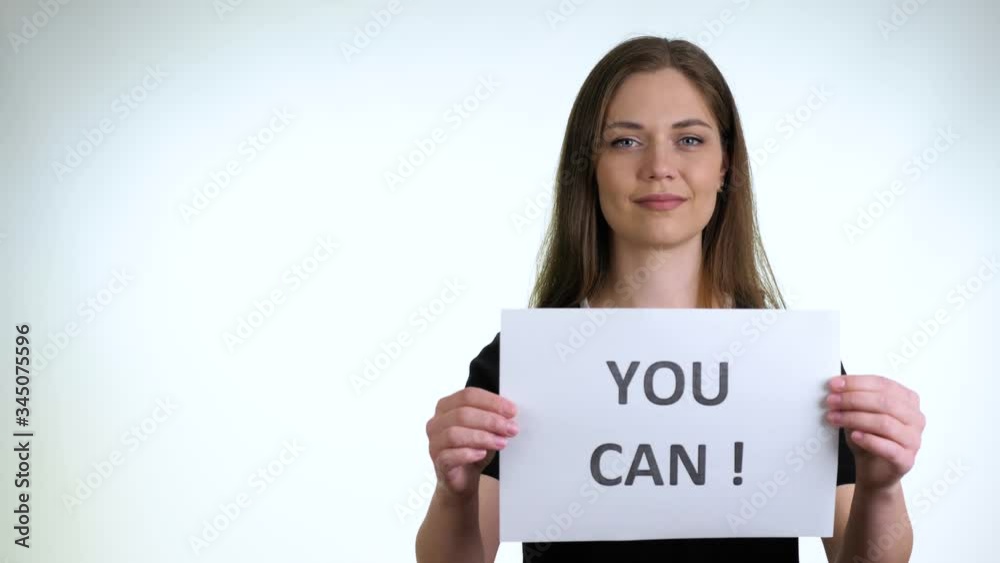 Pretty brunette girl in a black T-Shirt hold a sign Pretty brunette girl in a black T-Shirt hold a sign