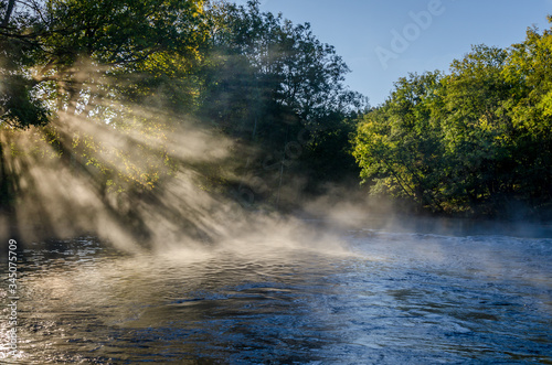 Magical morning  fog and sunshine at a river just outside Gothenburg  Sweden. View of a beautiful landscape  with trees  water  morning light and mist. Natural background with copy space.