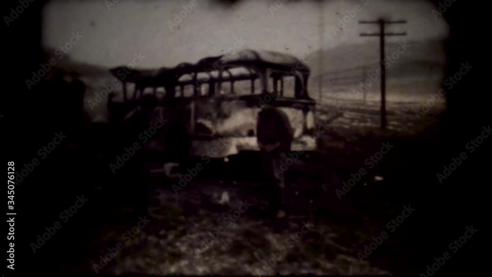 Old projector shows a movie with a World War II military destruction. Film runs through an 8mm projector