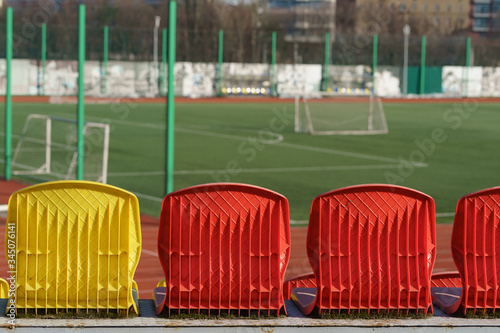 Photography of a football field at the public stadium in spring day. Stadium is closed.