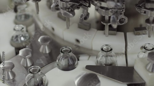 glass bottles on a medical solution conveyor at filling station close up medical industry