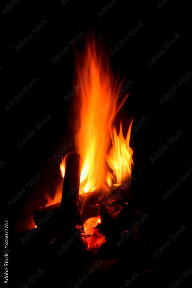 Close up on blazing campfire with dark surrounding