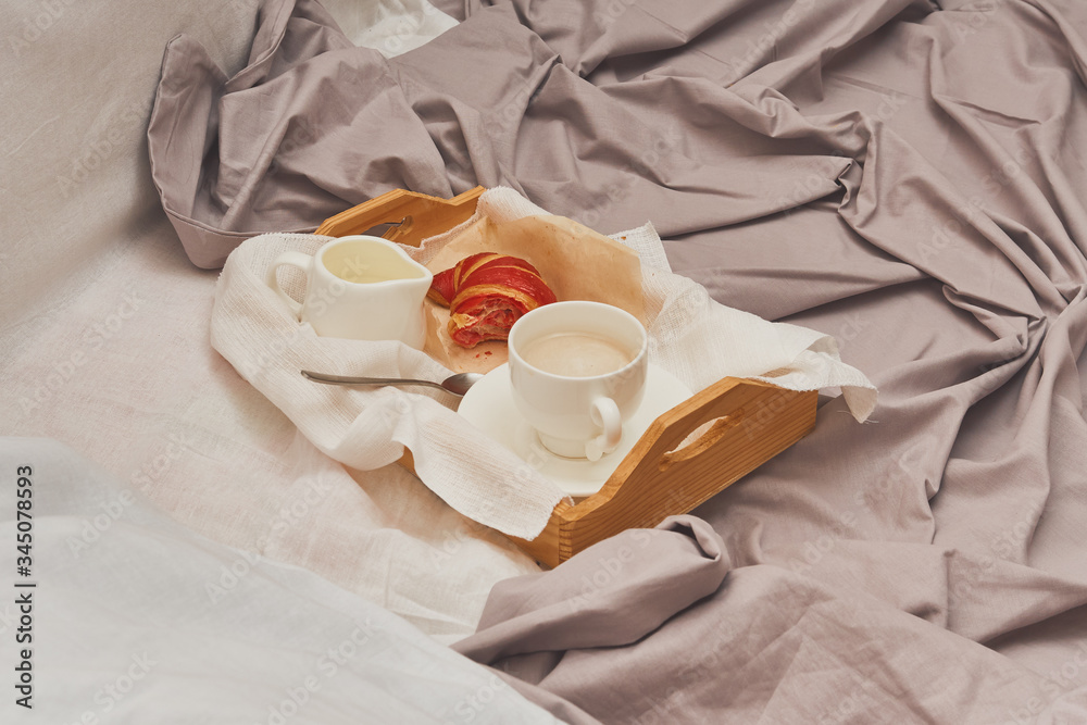 Breakfast in bed, coffee with cream, croissants in jam Breakfast in bed, coffee with cream, croissants in jam