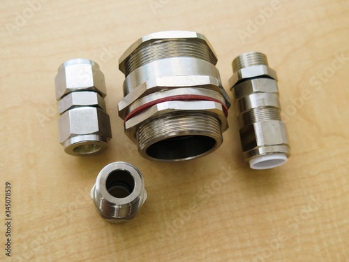 Explosion proof cable gland set isolated on wood background