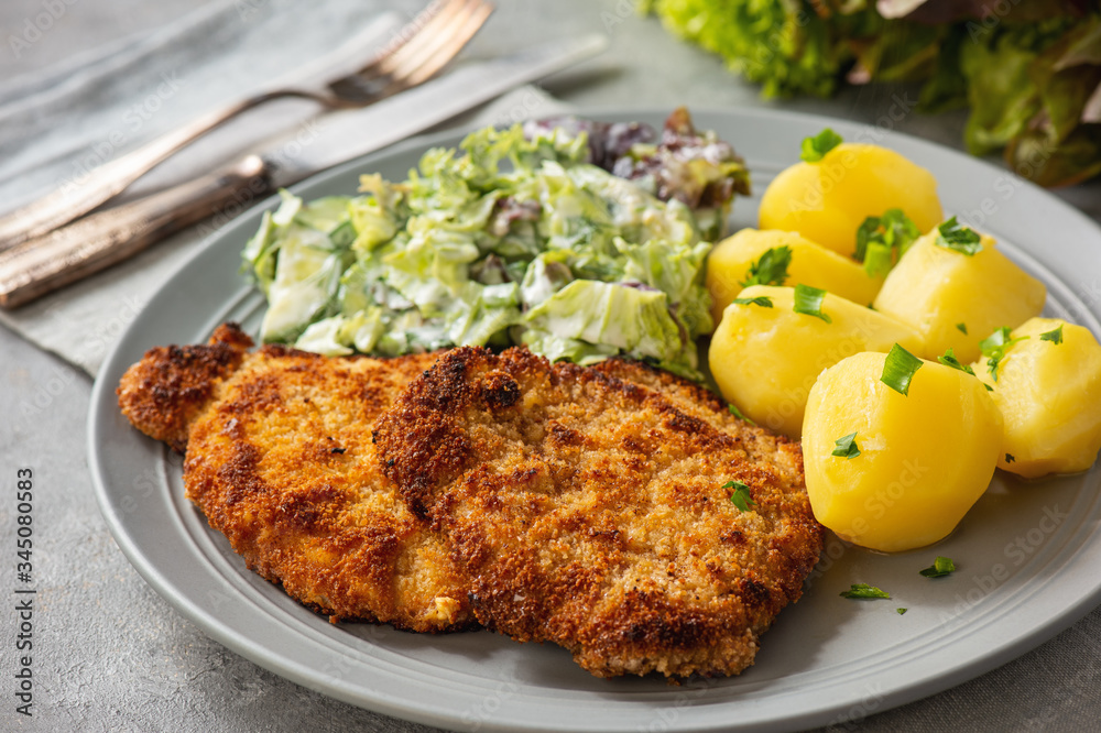 Chop pork cutlets , served with boiled potatoes and salad. - obrazy, fototapety, plakaty 