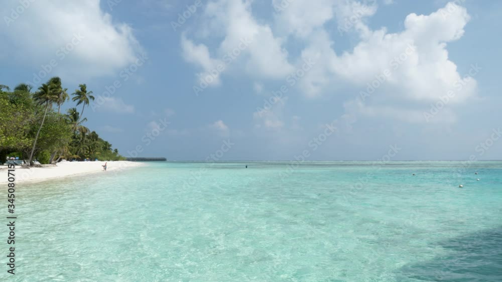 Maldives Island with Beach, Palms and Sea. Indian Ocean and Cloudy Sky. Beautiful Big Beach. Maldives Island with Beach, Palms and Sea. Indian Ocean and Cloudy Sky. Beautiful Big Beach.