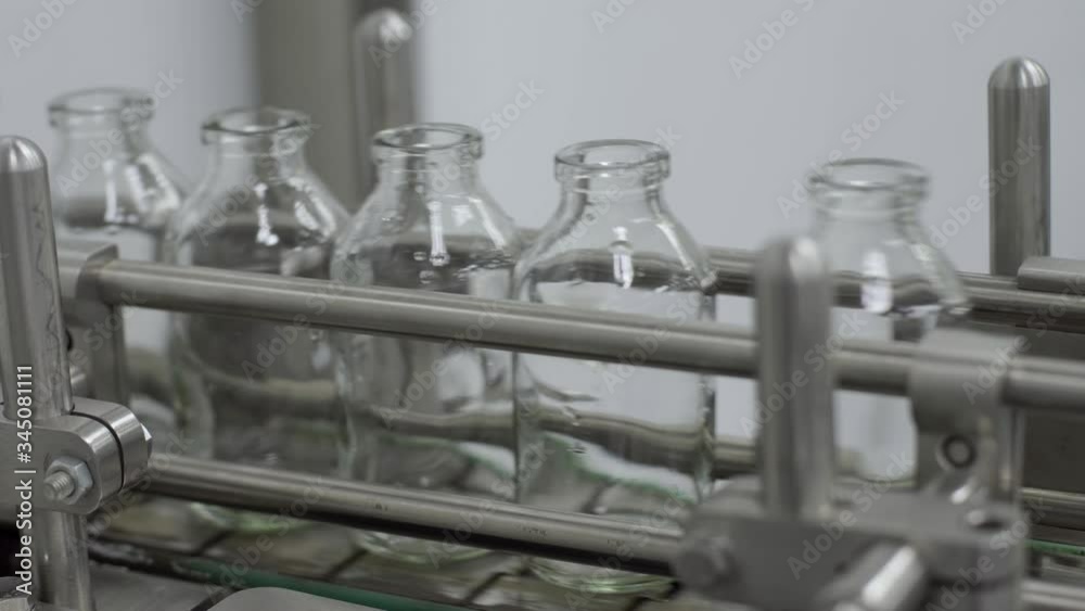 glass bottles on medical solution conveyor line close up medical industry glass bottles on medical solution conveyor line close up medical industry
