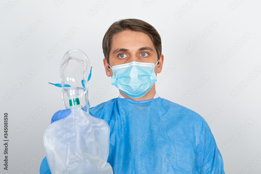 Doctor with protective uniform holding mask Doctor with protective uniform holding mask