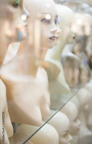 Naked female mannequins in the shop window.