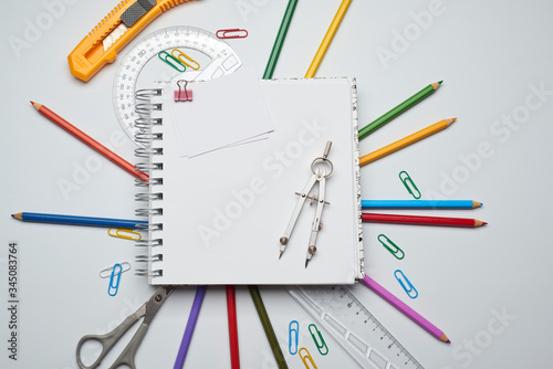 School note and supplies on a white background. Back to school, home creative workspace