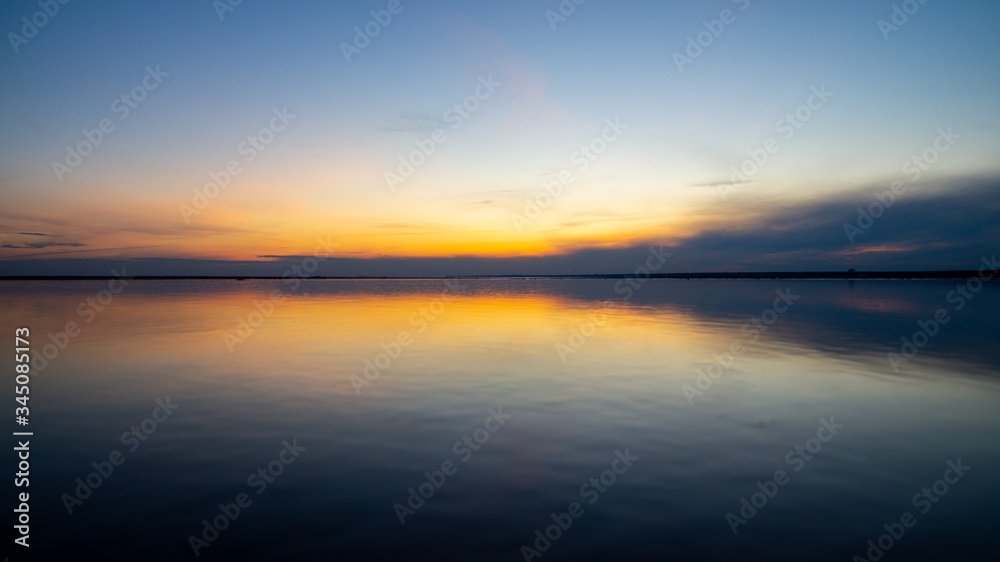 Sunset on the sandy beach, beach, beautiful sky, dramatic sky, sky reflected in the water.