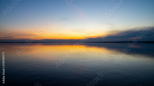 Sunset on the sandy beach, beach, beautiful sky, dramatic sky, sky reflected in the water. © Anton