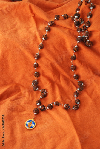 Rudraksha necklace on saffron cloth photo