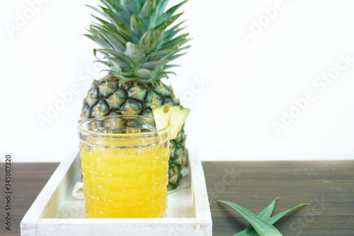 Pineapple juice is a fruit and herb on the table.