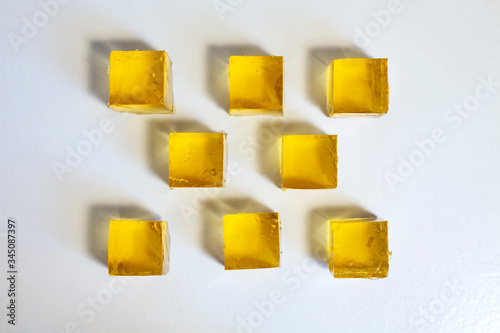 Apple jelly cubes on a white table