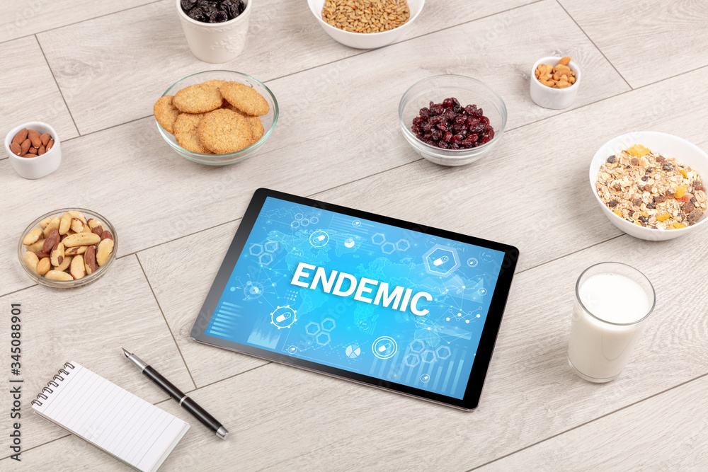 Healthy Tablet Pc compostion with ENDEMIC inscription, immune system boost concept Healthy Tablet Pc compostion with ENDEMIC inscription, immune system boost concept