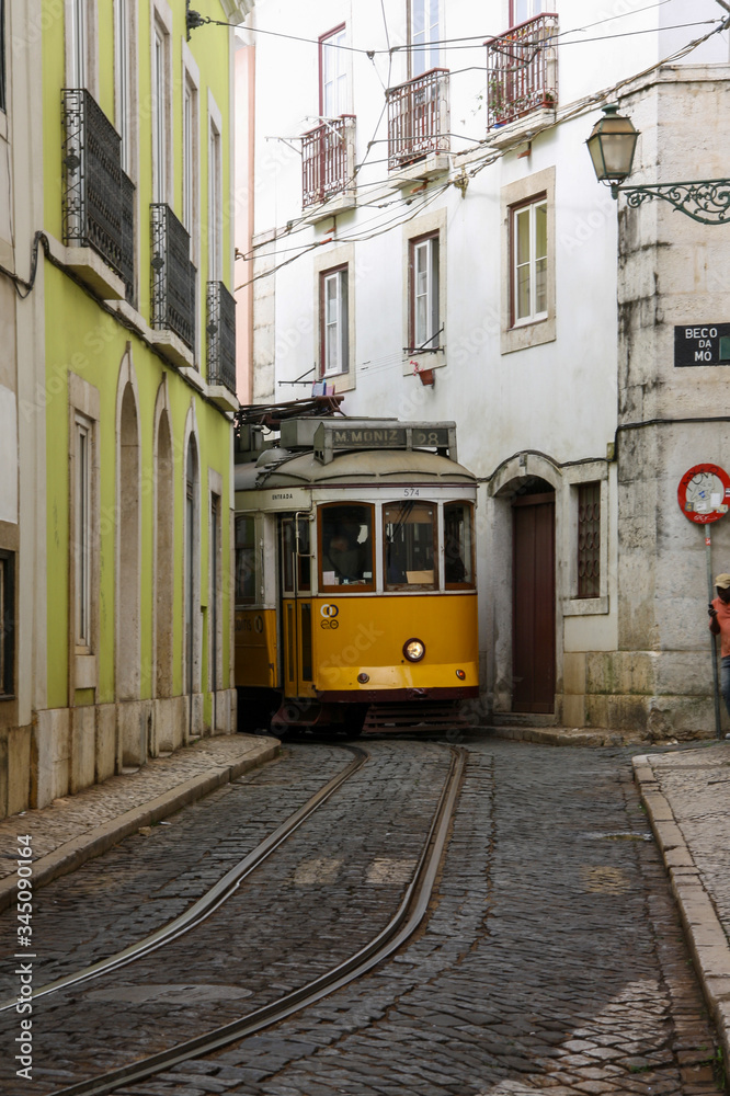 Cable car in a narrow street in Lisbon