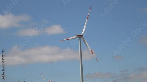 Wind generator against blue sky background