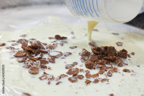 Fotografie Fresh milk is poured onto a frozen metal surface as the basis for making homemad