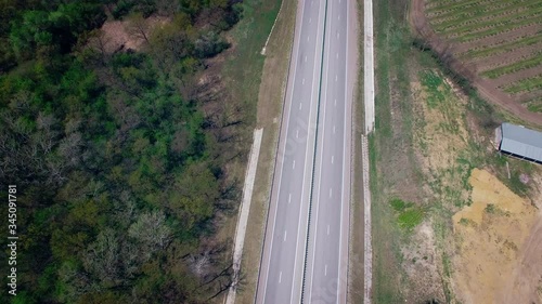 Aerial view of road cars with mountains in the background,flying camera