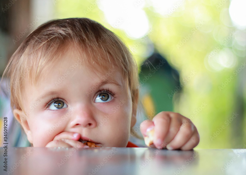 cute Baby sitting at the table. copy the spaces for your text cute Baby sitting at the table. copy the spaces for your text
