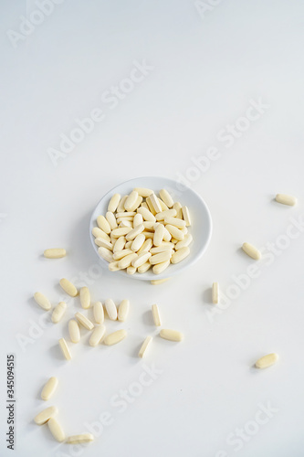 yellow pills in a plate on the table