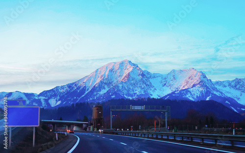 Road with twilight view of Alps mountains in Austria reflex