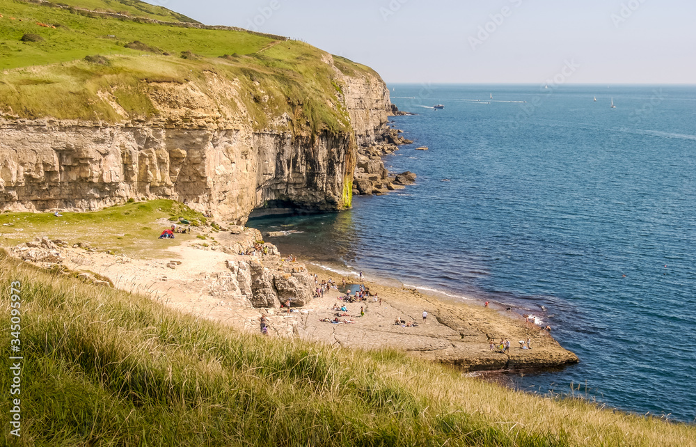 Looking East along the Jurassic Coast with the famous Dancing Ledge near Langton Matravers, Swanage, Dorset, UK on a warm and sunny Summer afternoon