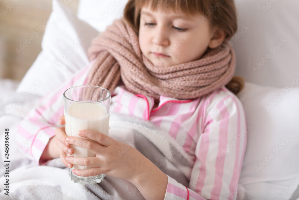 Little girl ill with flu drinking milk in bedroom Little girl ill with flu drinking milk in bedroom
