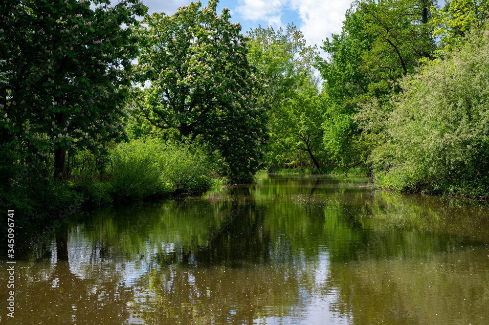 Green park with ponds and old water mill in central part of Eindhoven city, North Brabant, Netherlands in spring time. Green park with ponds and old water mill in central part of Eindhoven city, North Brabant, Netherlands in spring time.