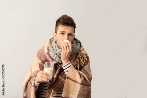 Young man ill with flu hold...