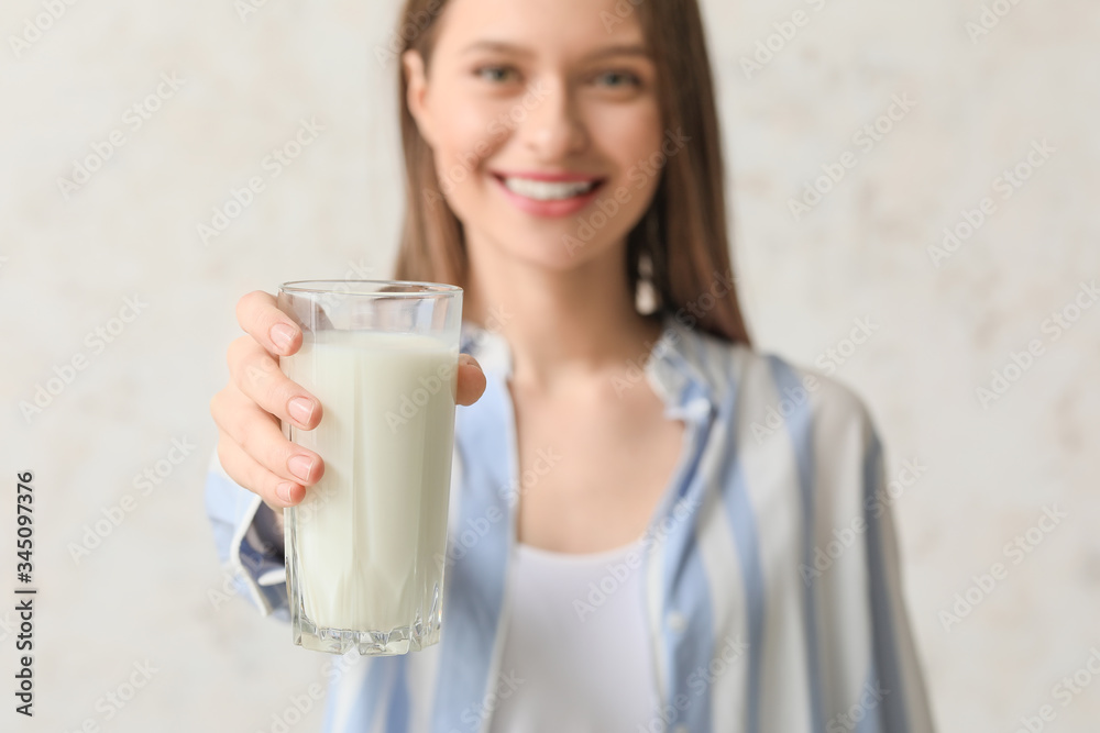 Young woman with glass of milk on light background Young woman with glass of milk on light background