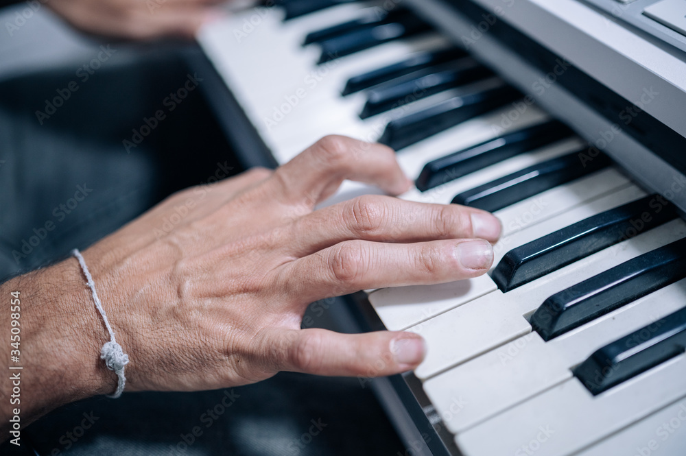 Hands playing a midi keyboard in a music studio.Learning,music instruments concept