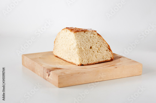 Slice of a homemade loaf of white bread on a wooden table