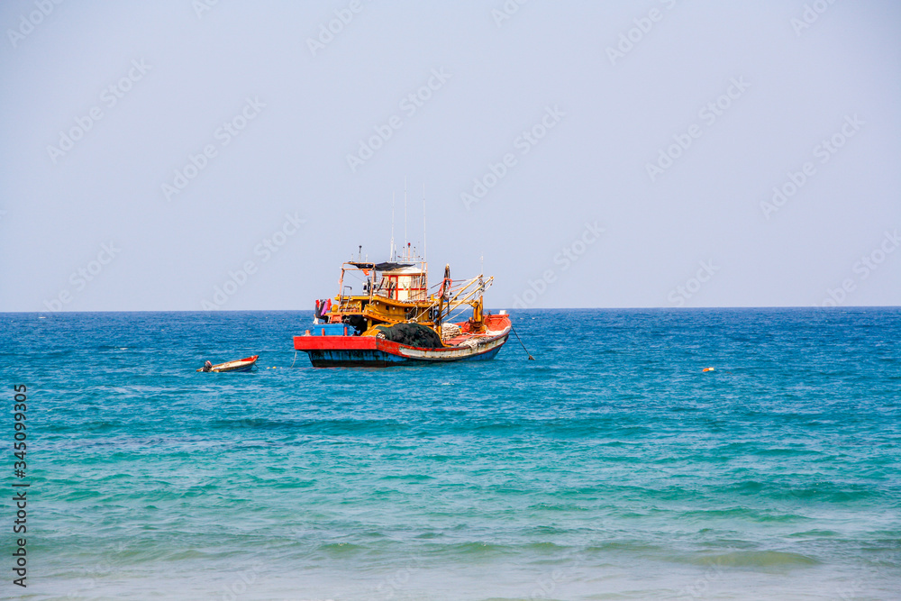 Fototapeta premium Old fishing boat in Cambodia with blue sky