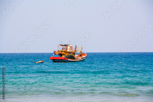 Old fishing boat in Cambodia with blue sky