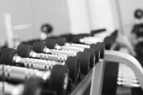 Dumbbells on stand in modern gym