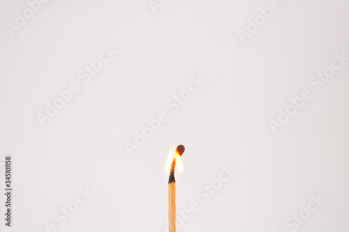 Burning match on white background