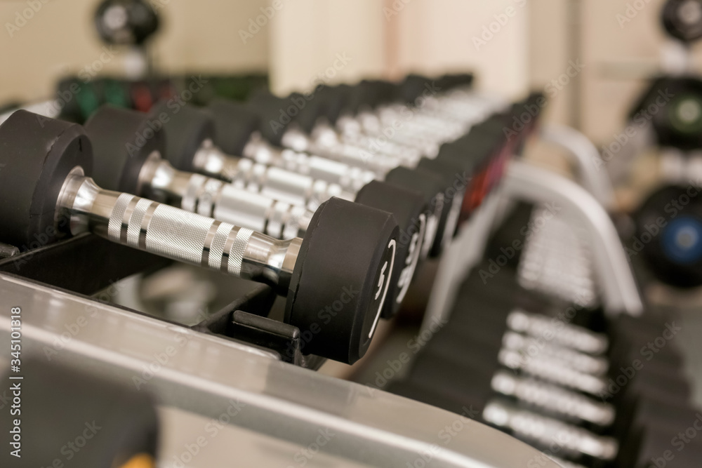 Dumbbells on stand in modern gym Dumbbells on stand in modern gym