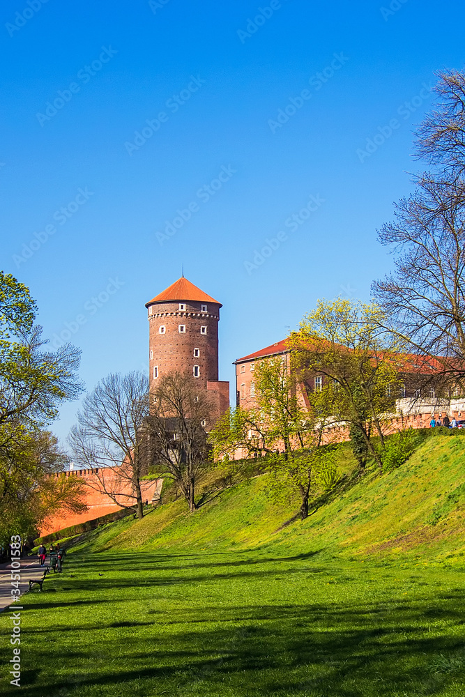 View on the red brick Sandomierska Tower (fire tower) at sunny day, part of the Wawel Royal Castle on Wawel Hill in Krakow, Poland.