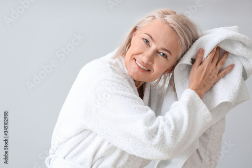 Happy mature woman in bathr...