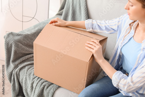 Young woman unpacking parce...