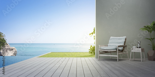 Armchair on terrace near swimming pool and garden in modern beach house or luxury villa. Wooden deck 3d rendering with sea view.
