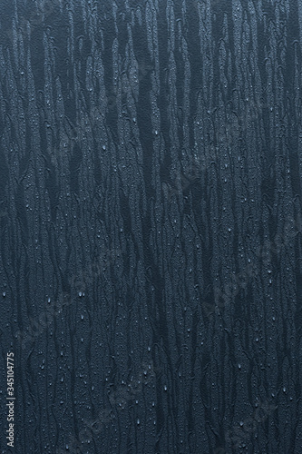 Dark blue wall texture with rain drops on vertical