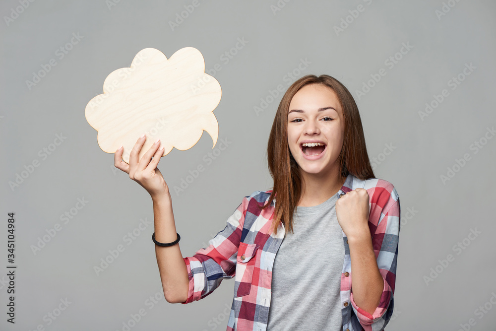 Joyful screaming teen girl holding thinking bubble Joyful screaming teen girl holding thinking bubble
