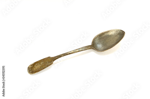 Old antique spoon on a white background. Isolated