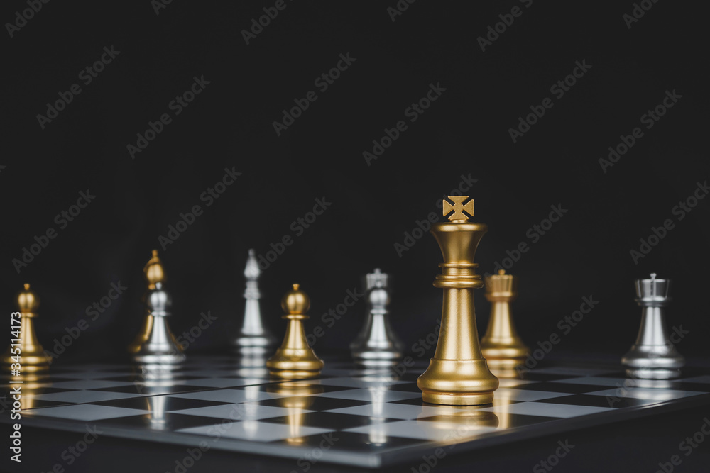 Winner. shot of gold king surrounded with silver chess pieces on chess board game competition with dark background, chess battle, victory, success, team leader, teamwork and business strategy concept Winner. shot of gold king surrounded with silver chess pieces on chess board game competition with dark background, chess battle, victory, success, team leader, teamwork and business strategy concept
