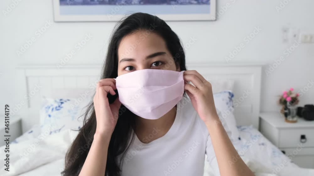 4k Young Asian girl wear a surgical mask to protect from virus and flu. 4k Young Asian girl wear a surgical mask to protect from virus and flu.